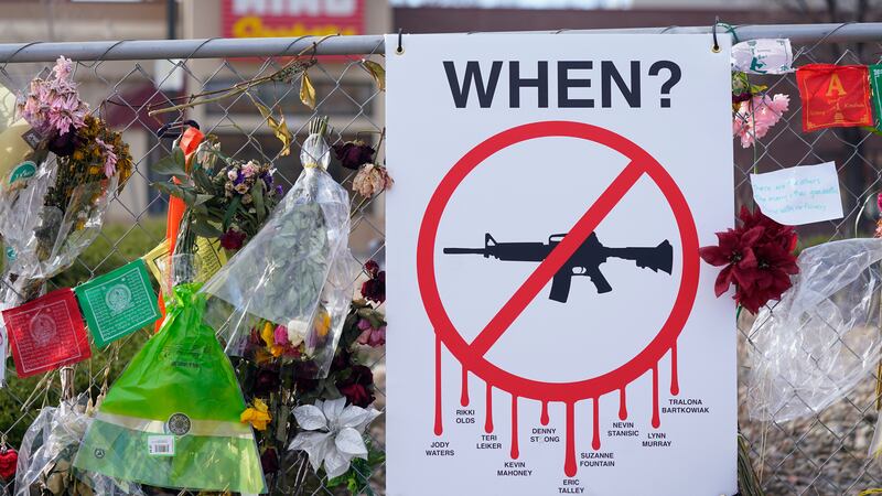 FILE - Tributes hang on the temporary fence surrounding the parking lot in front of a King...