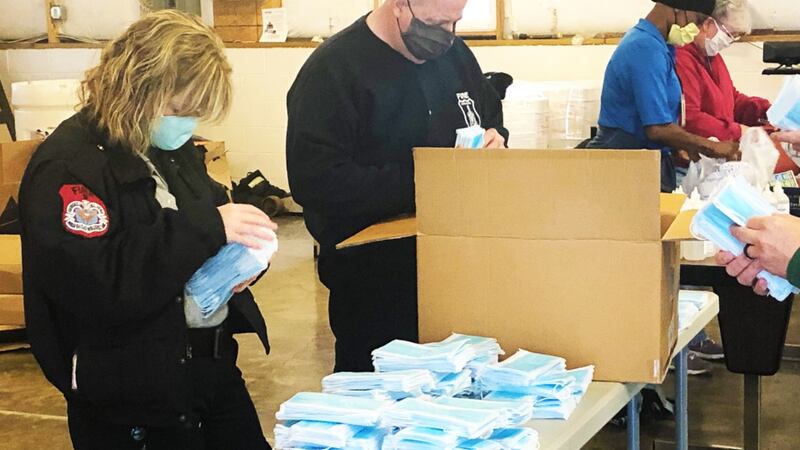 City of Harrisonburg staff and volunteers pack care kits for distribution throughout the...