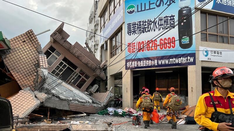This photo provided by Hualien County fire department show firefighters in the search for...