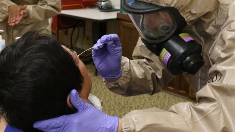 Virginia National Guard Soldiers and Airmen collect samples for COVID-19 testing at a...