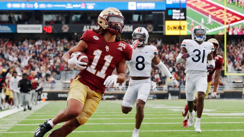 Boston College wide receiver Lewis Bond (11) runs for a touchdown in front of Virginia...
