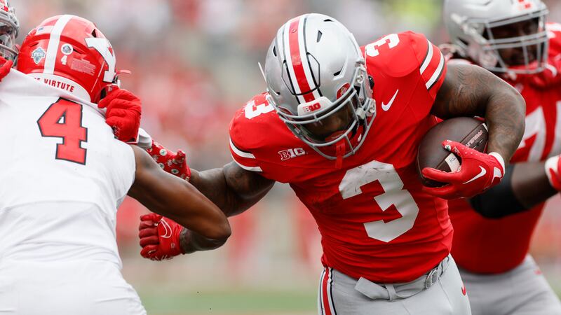 Ohio State running back Miyan Williams, right, runs past Youngstown State defensive back Tyjon...