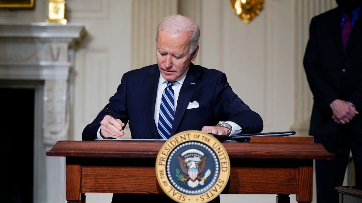 FILE - In this Jan. 27, 2021 file photo, President Joe Biden signs an executive order on...